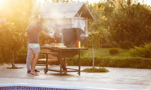 young-men-roasting-barbecue-grill-cottage-countryside